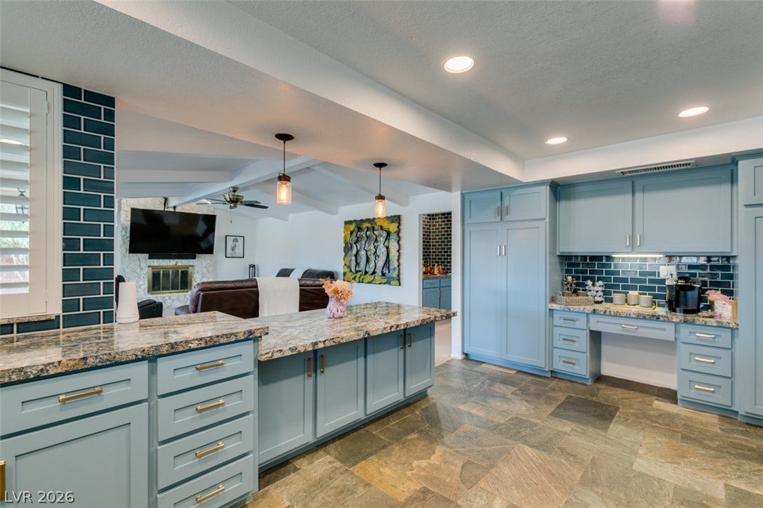 2246 Almart Circle, Henderson, NV 89014 Gleaming stone countertops and custom cabinetry define this thoughtfully designed culinary workspace.
