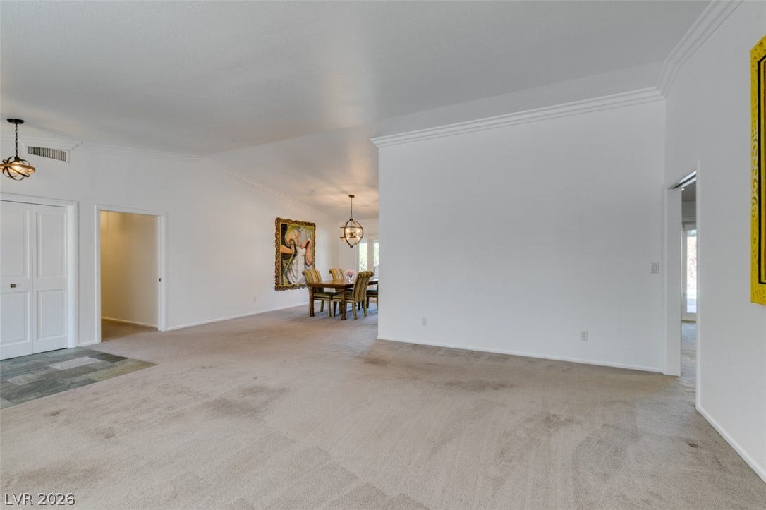 2246 Almart Circle, Henderson, NV 89014 An open floorplan flows seamlessly from the carpeted living area toward the dining room.
