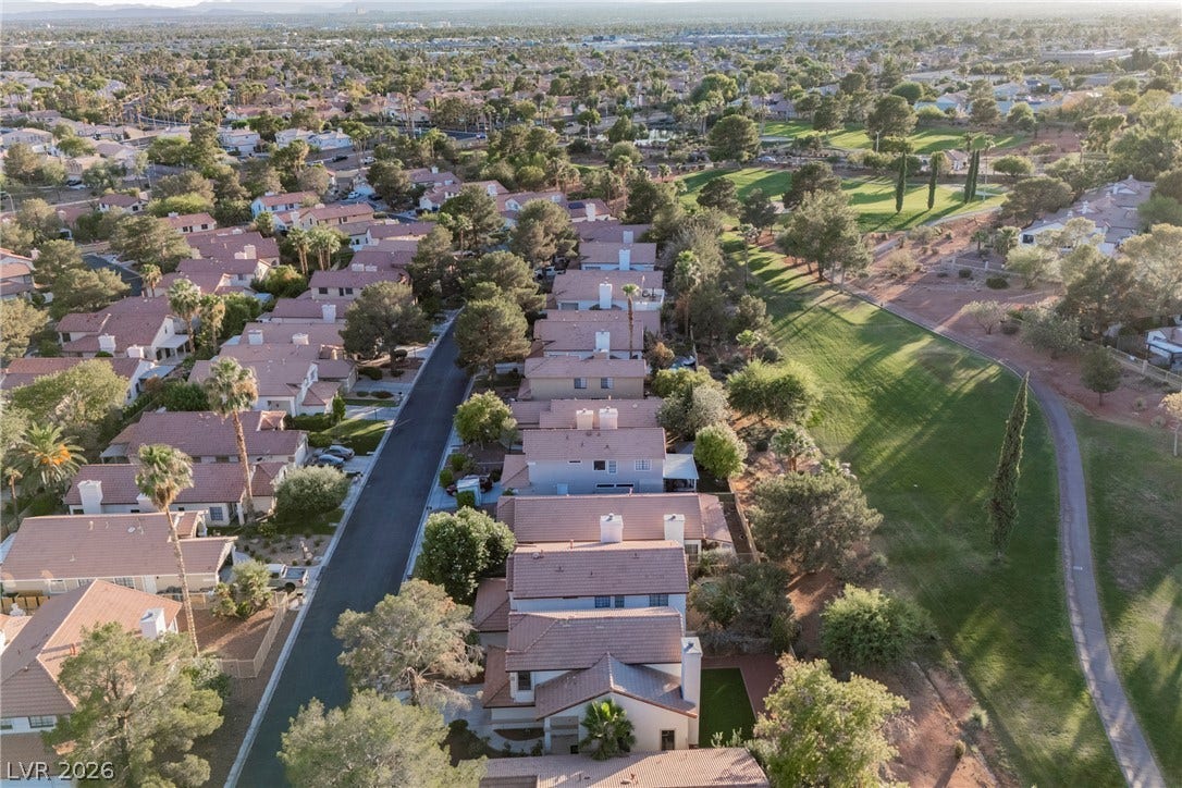 4877 Fiesta Lakes Street, Las Vegas, NV 89130 An aerial perspective showcases a peaceful neighborhood bordered by a lush golf course.