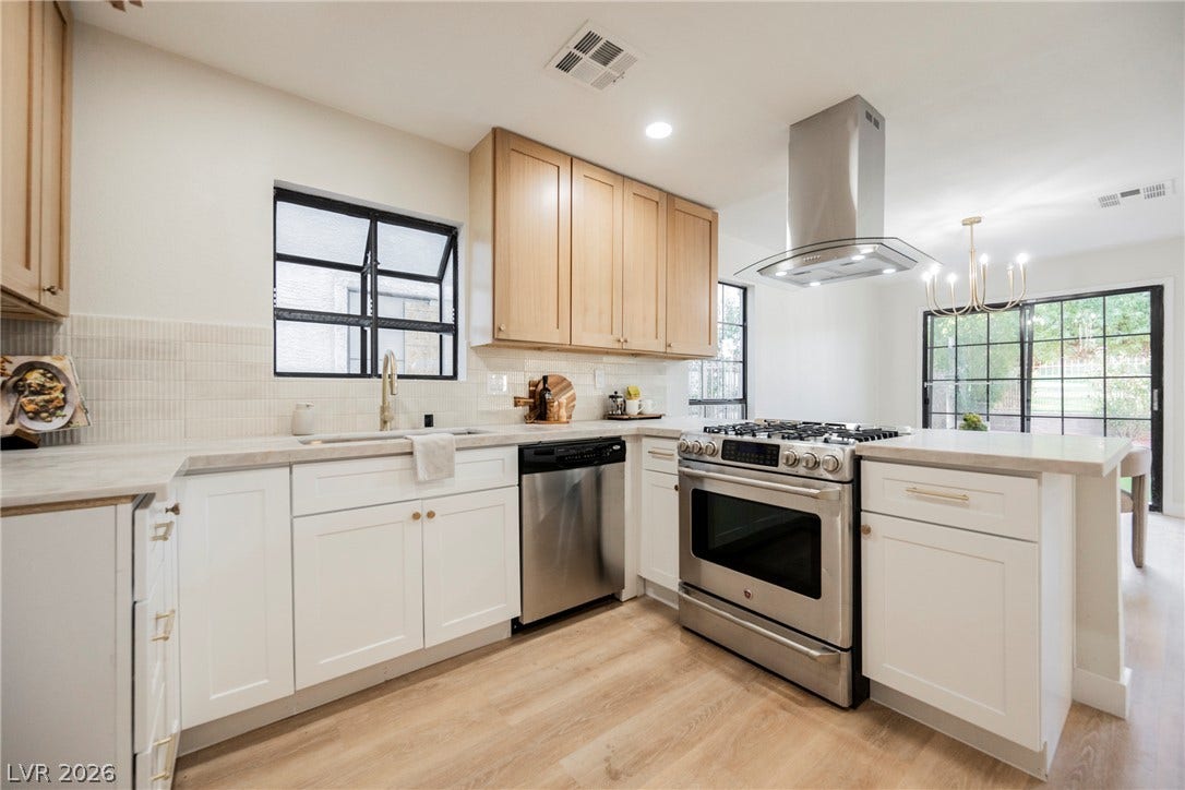 4877 Fiesta Lakes Street, Las Vegas, NV 89130 Crisp white cabinetry paired with warm wood tones defines this airy, light-filled kitchen space.