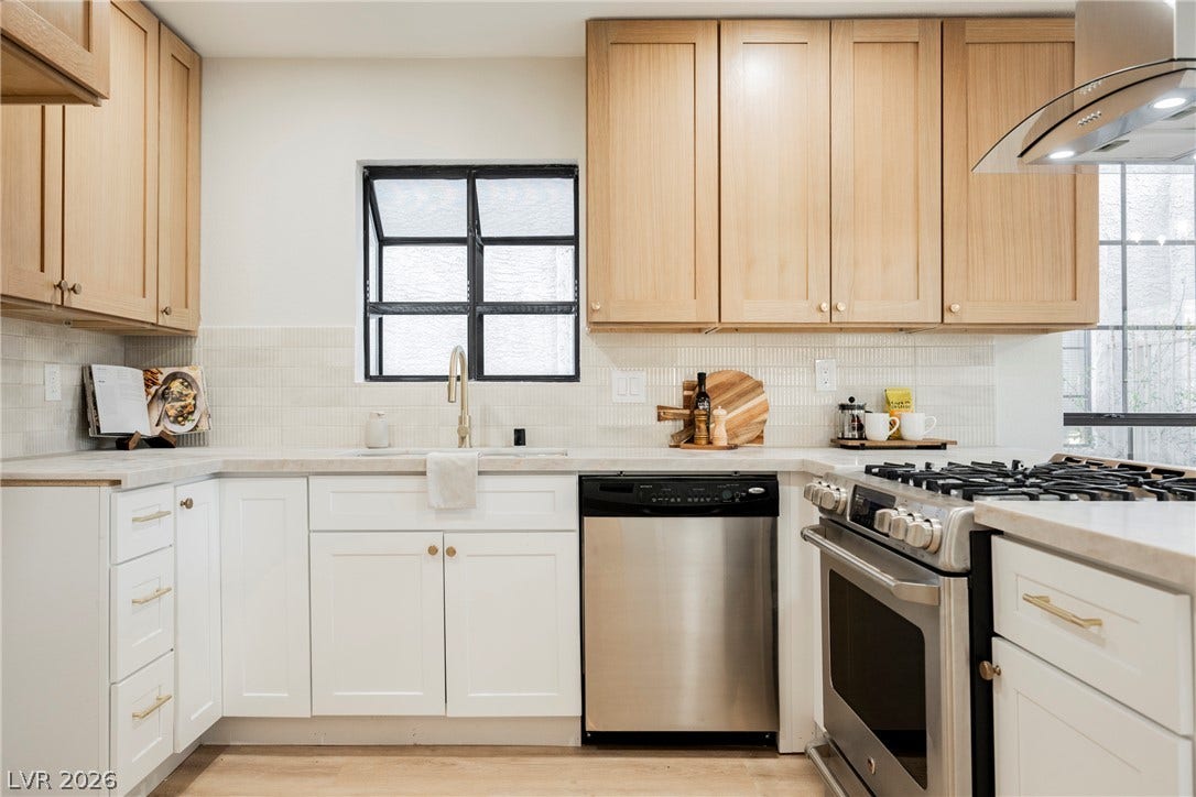 4877 Fiesta Lakes Street, Las Vegas, NV 89130 Natural wood cabinets and light stone countertops elevate this modern cooking space.