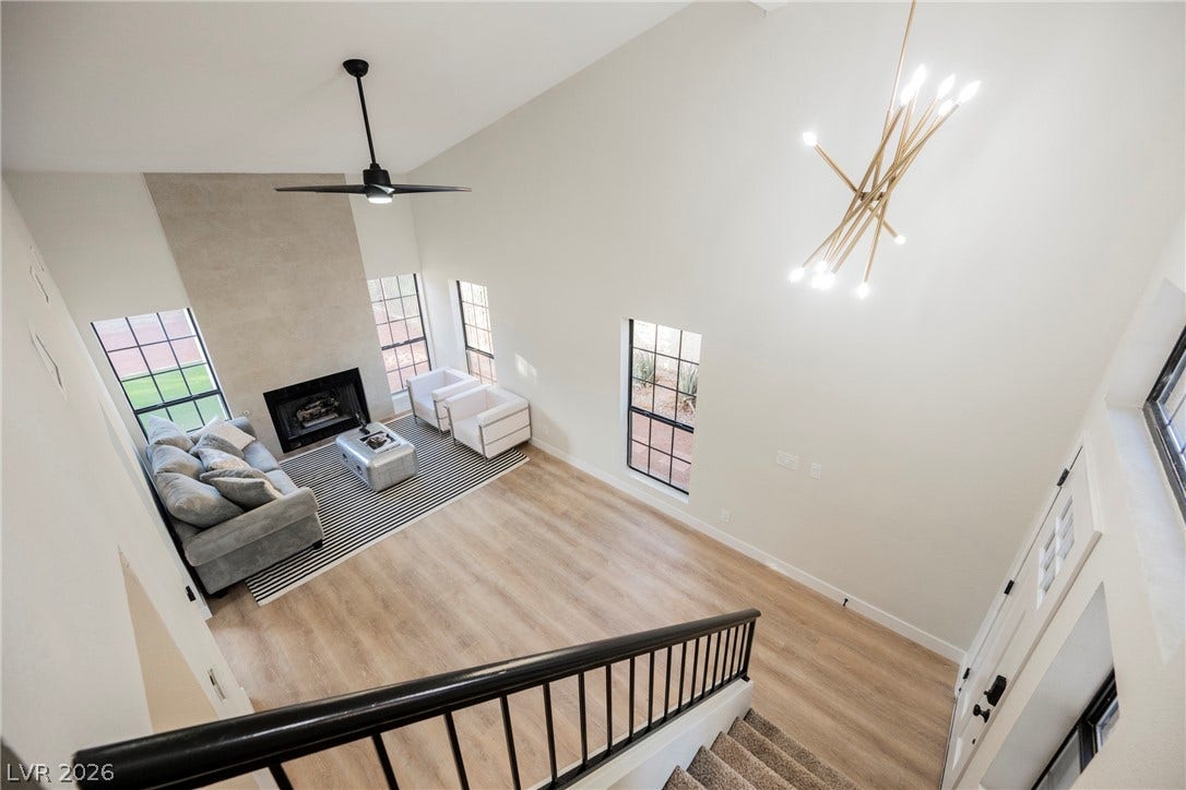 4877 Fiesta Lakes Street, Las Vegas, NV 89130 A high, vaulted ceiling and generous windows elevate this light-filled main living space.