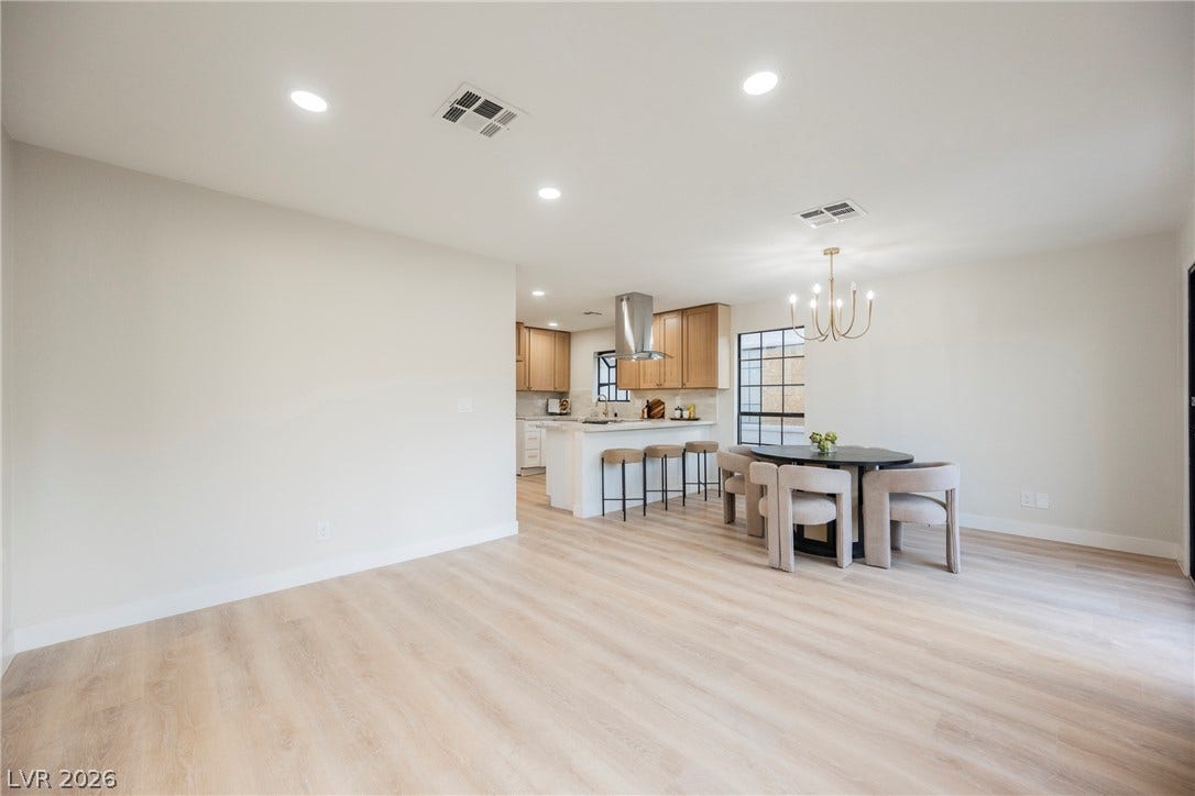 4877 Fiesta Lakes Street, Las Vegas, NV 89130 Smooth wood floors flow seamlessly through this open-concept living area and adjacent kitchen.