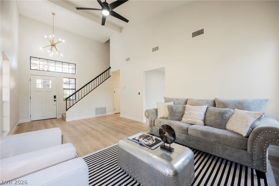 4877 Fiesta Lakes Street, Las Vegas, NV 89130 High ceilings and clean plank flooring define this airy entryway and living space.