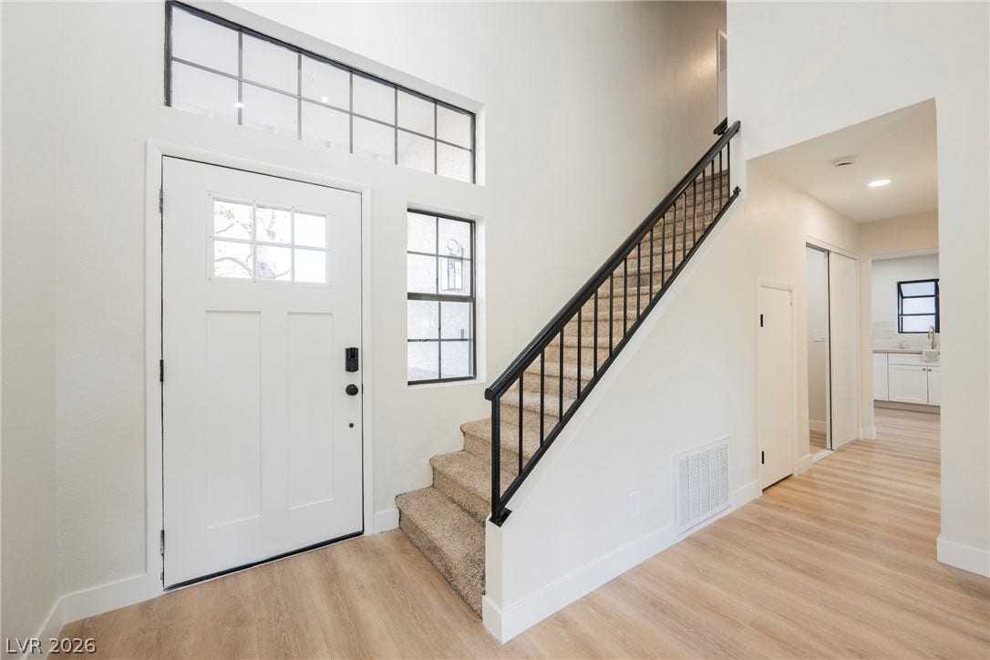 4877 Fiesta Lakes Street, Las Vegas, NV 89130 An inviting entry foyer displays high ceilings, multi-level stairs, and durable wood-look flooring.
