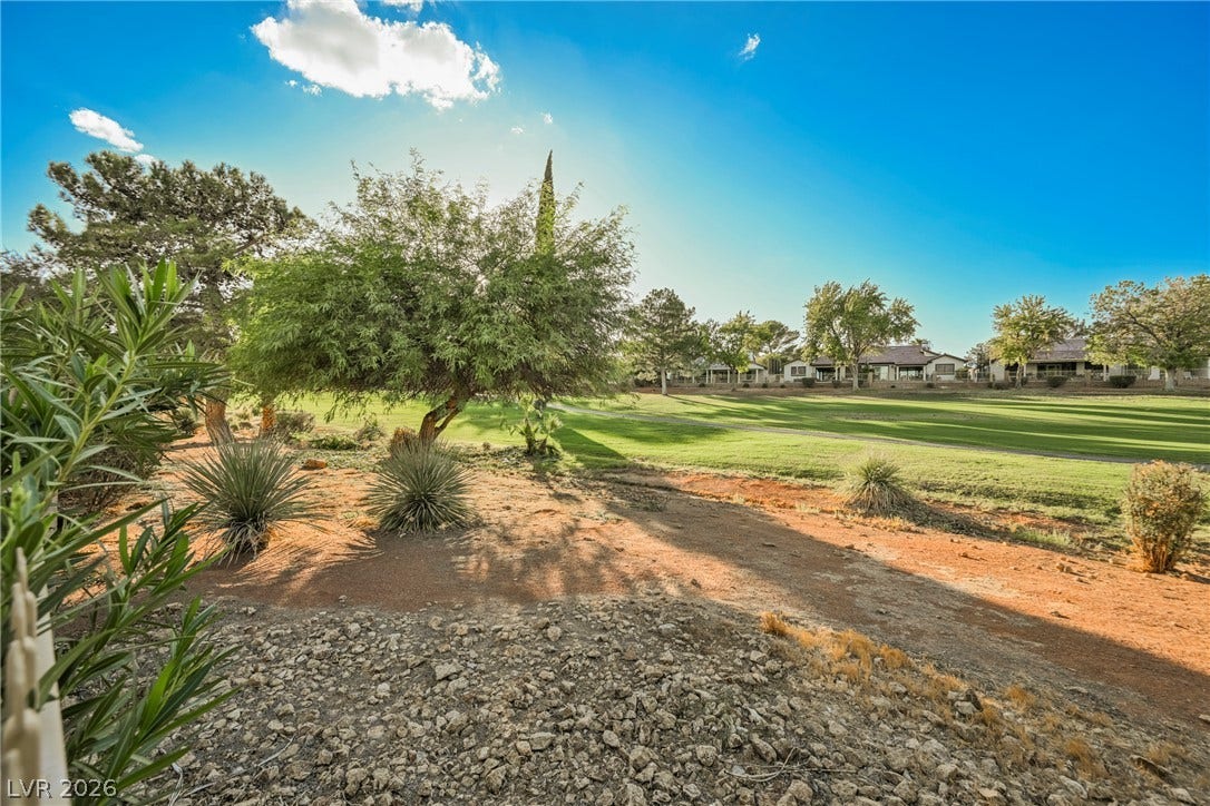 4877 Fiesta Lakes Street, Las Vegas, NV 89130 Lush fairways and mature desert landscaping create a scenic backdrop under wide open skies.
