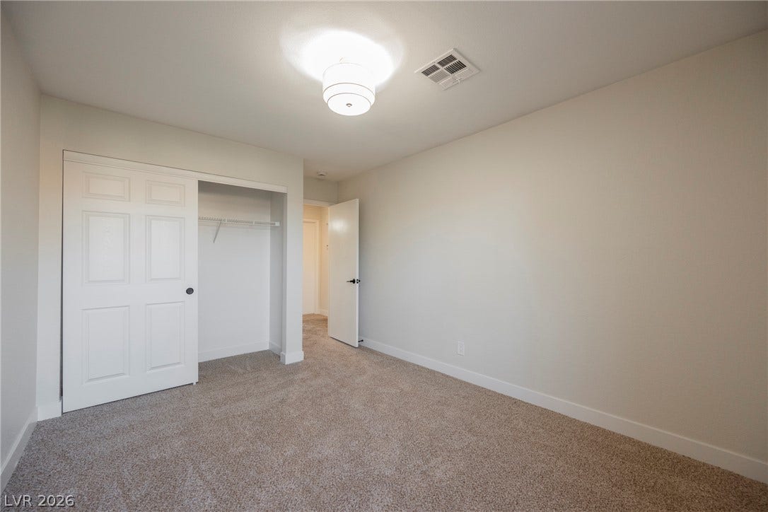 4877 Fiesta Lakes Street, Las Vegas, NV 89130 Soft carpeting underfoot defines this inviting bedroom layout complete with a functional closet.