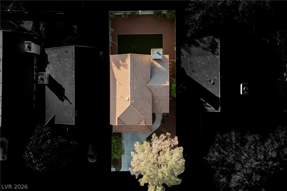 4877 Fiesta Lakes Street, Las Vegas, NV 89130 An aerial perspective showcases the classic tile roof design and private fenced backyard.
