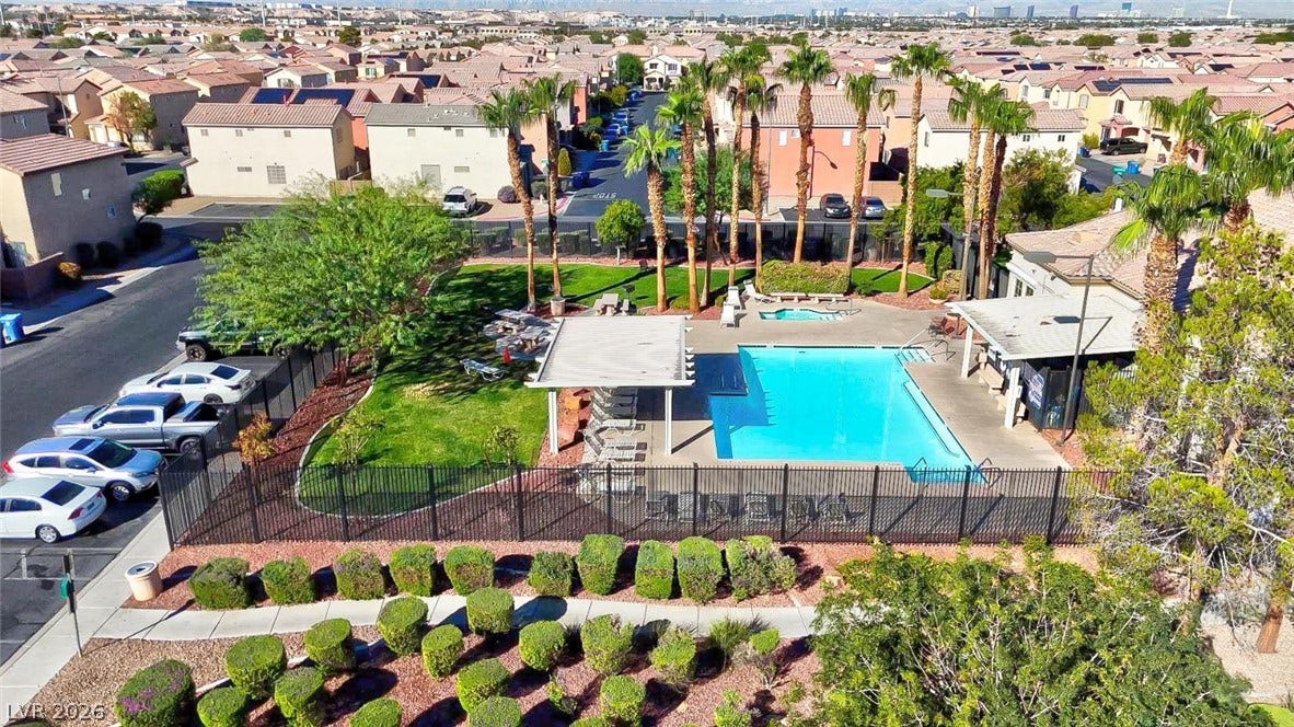 A sparkling community swimming pool serves as a central neighborhood gathering space.