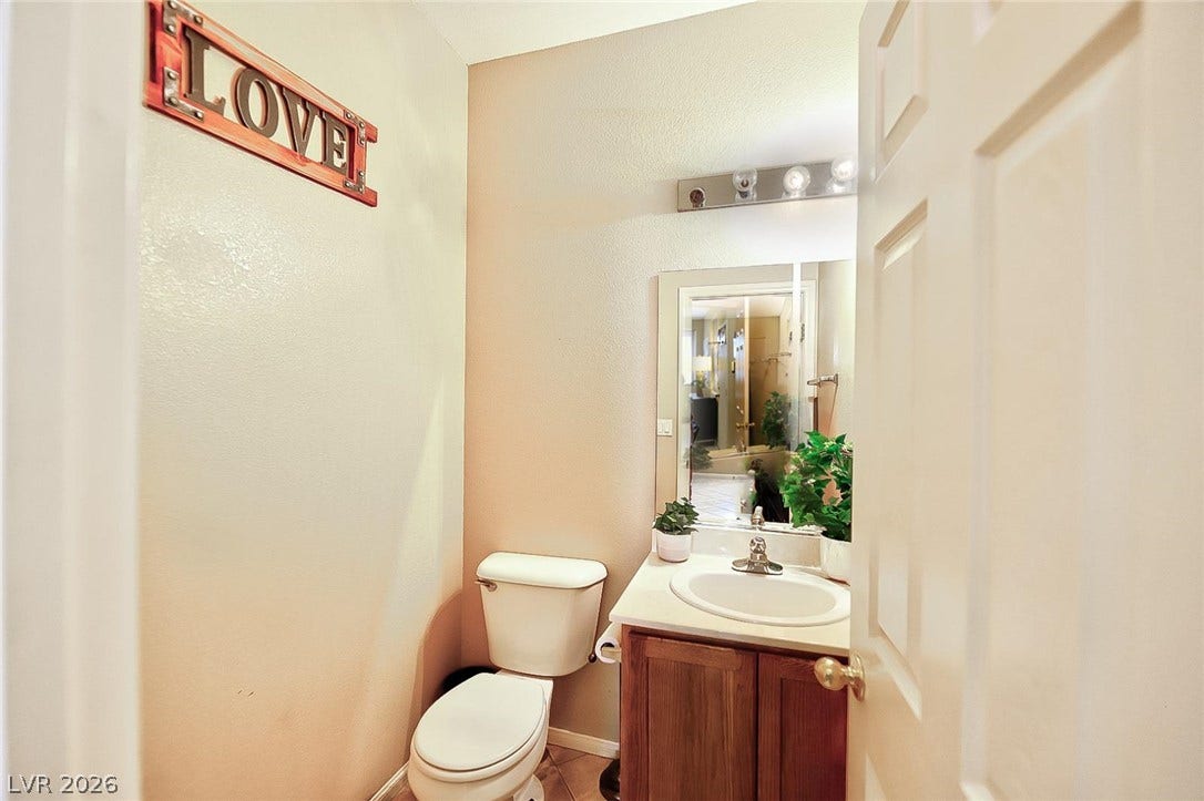 A well-positioned vanity with under-sink storage anchors this functional half bath.