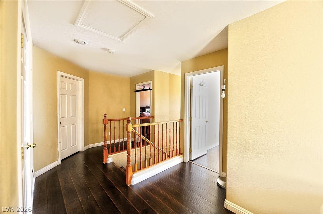 Rich dark wood flooring guides the way through this upper-level landing and hallway.