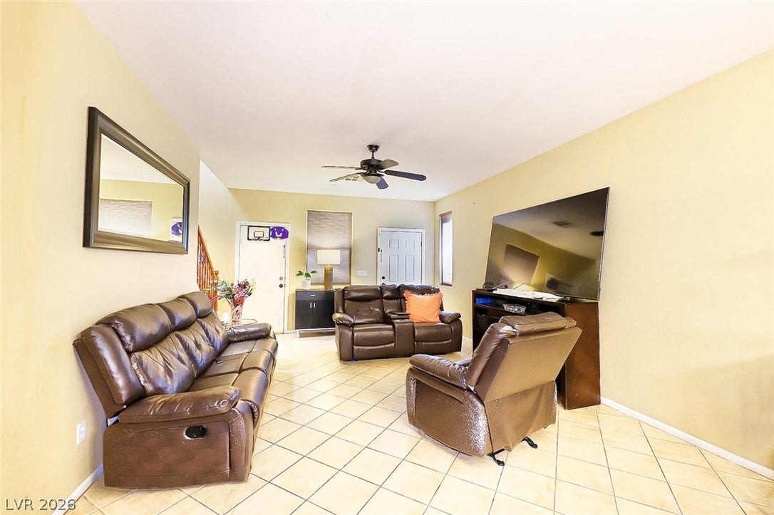 Tiled flooring and high ceilings elevate this inviting, open living area.