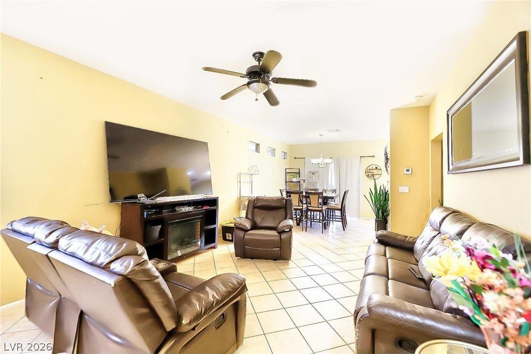 An open floorplan connects the comfortable living space to the adjacent dining area.