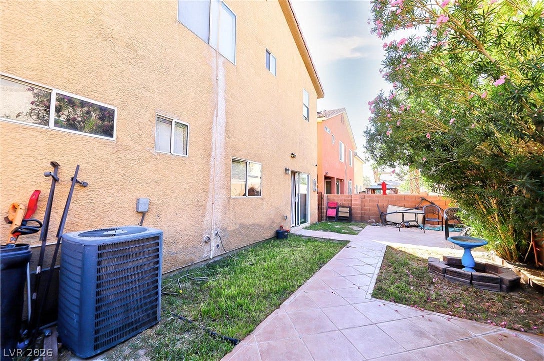 Tiled walkways wind through the private backyard highlighting the low-maintenance stucco exterior.