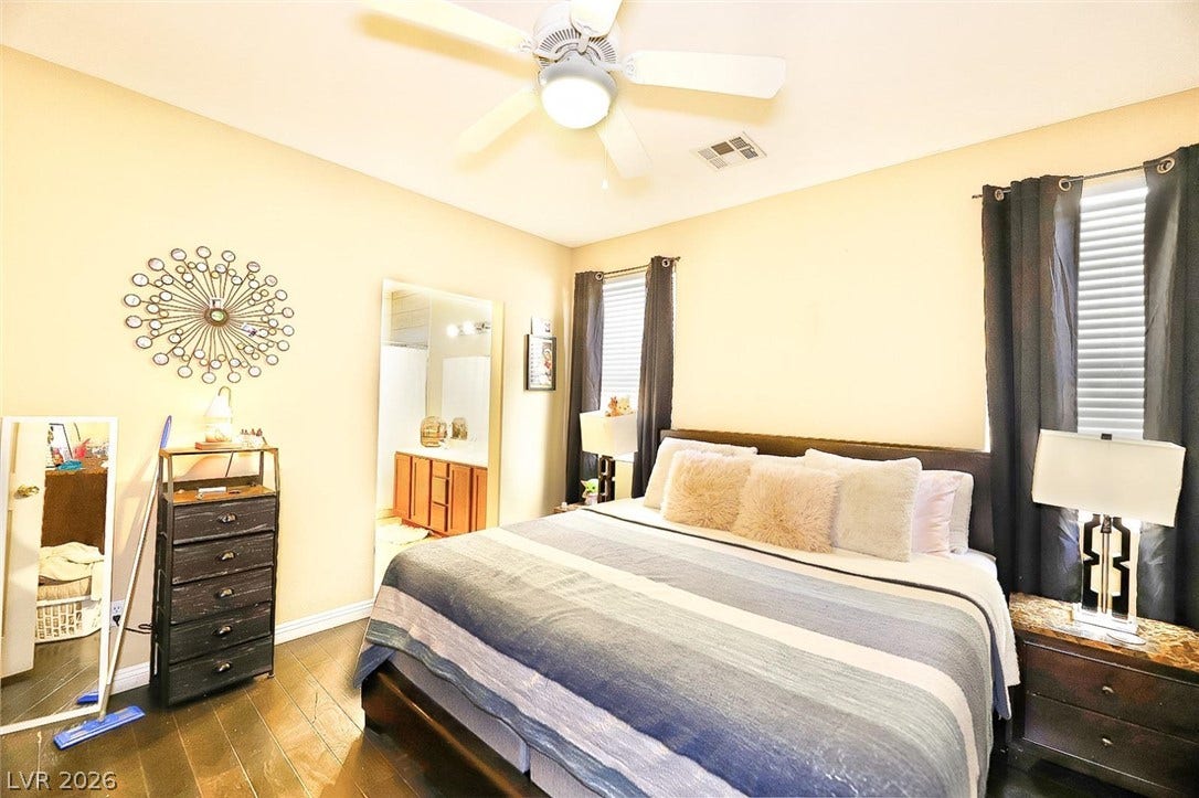 Gleaming hardwood floors and classic window frames anchor this comfortable sleeping space.