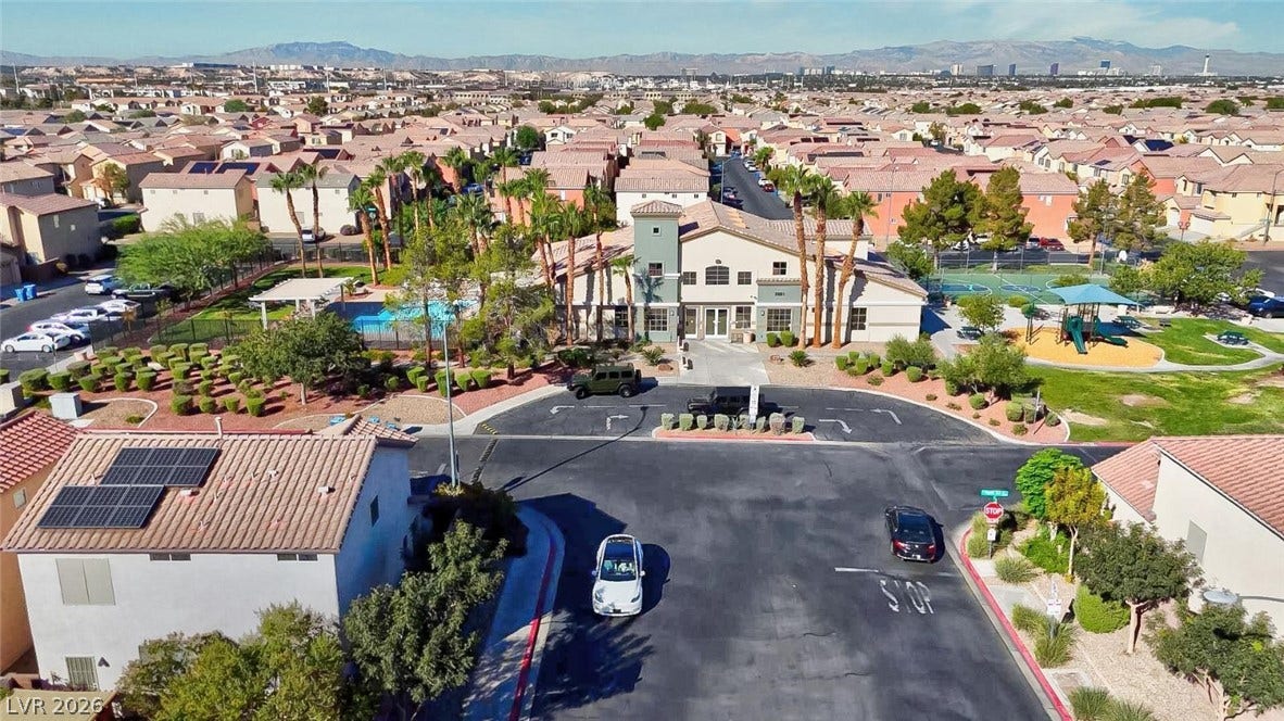 An aerial perspective showcases a vibrant community clubhouse with an inviting pool and playground.