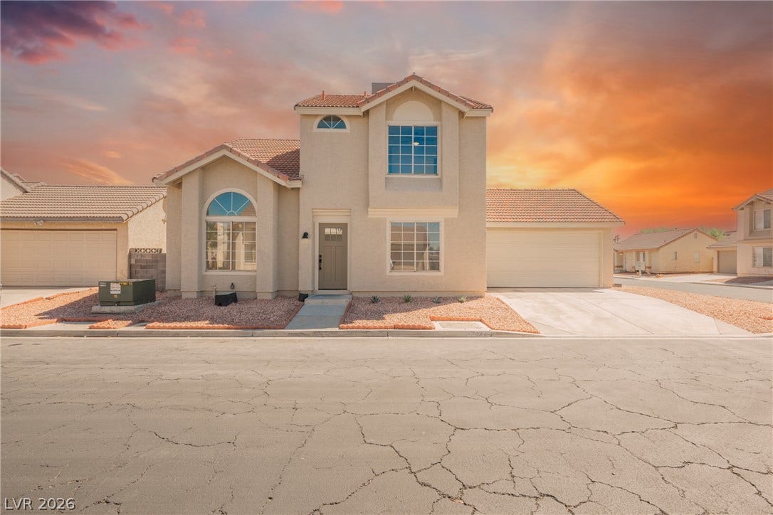 2822 Sesame Drive, Las Vegas, NV 89142 Two-story stucco architecture featuring clean lines, arched windows, and a multi-vehicle garage.