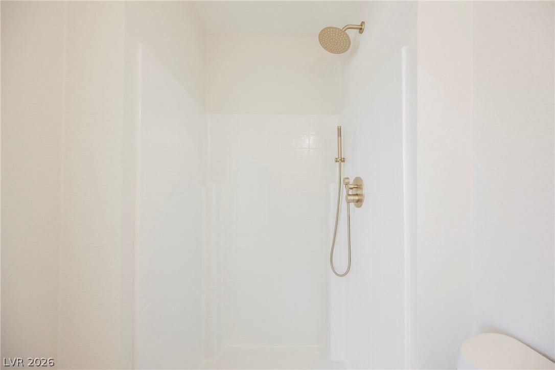 2822 Sesame Drive, Las Vegas, NV 89142 Minimalist design defines this sleek shower stall accented by modern gold fixtures.