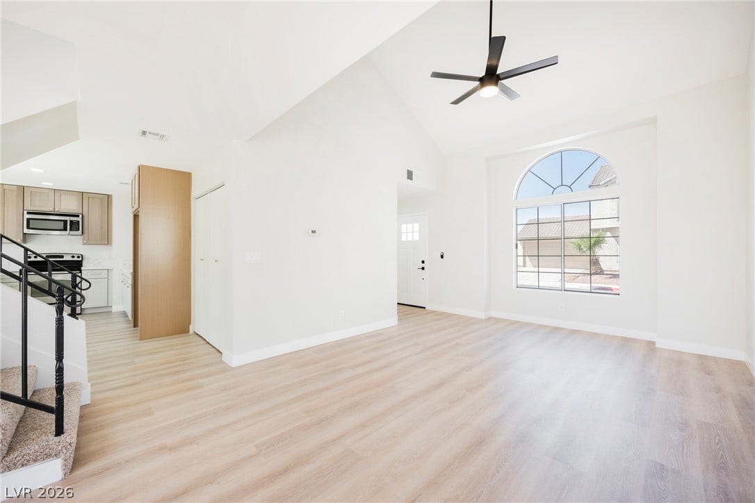 2822 Sesame Drive, Las Vegas, NV 89142 Soaring vaulted ceilings and light wood-plank flooring define this airy open-concept living space.