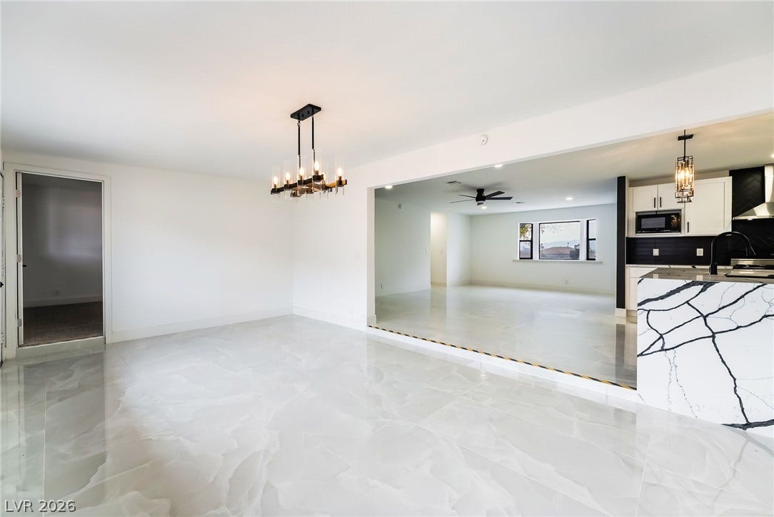 Polished tile flooring and an open layout connect the dining and living spaces seamlessly.