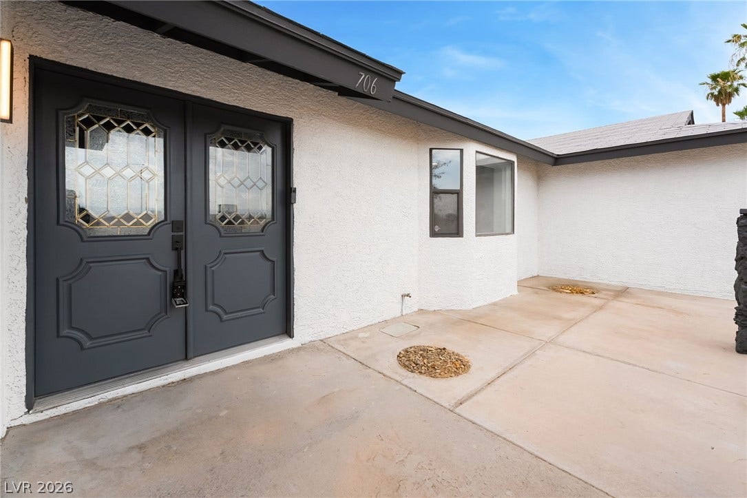 Double doors with decorative glass panels welcome guests at the main entryway.