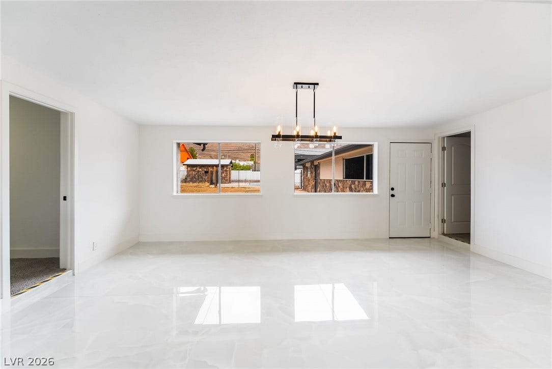 Gleaming polished flooring and minimalist design create an airy, modern atmosphere in this versatile space.