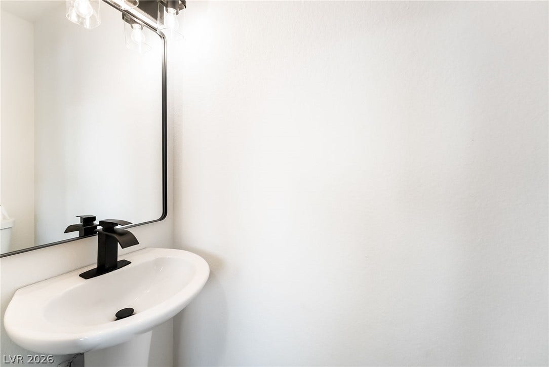 Clean lines and modern fixtures define this minimalist powder room space.