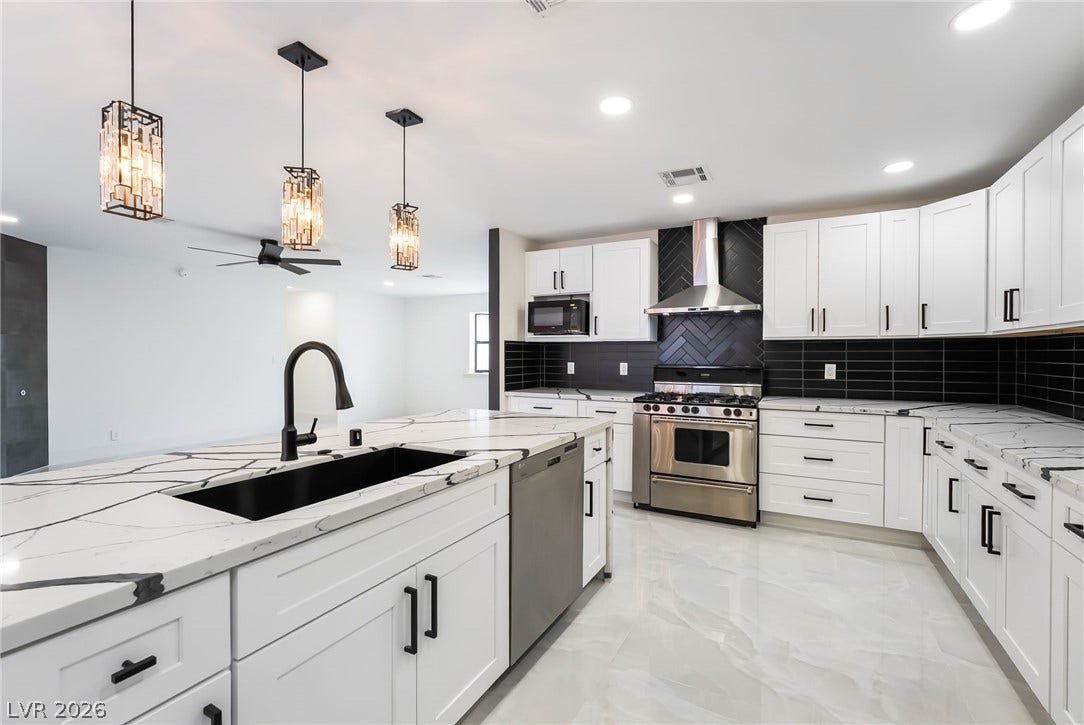 Gleaming stone countertops and sleek cabinetry define this contemporary culinary space.