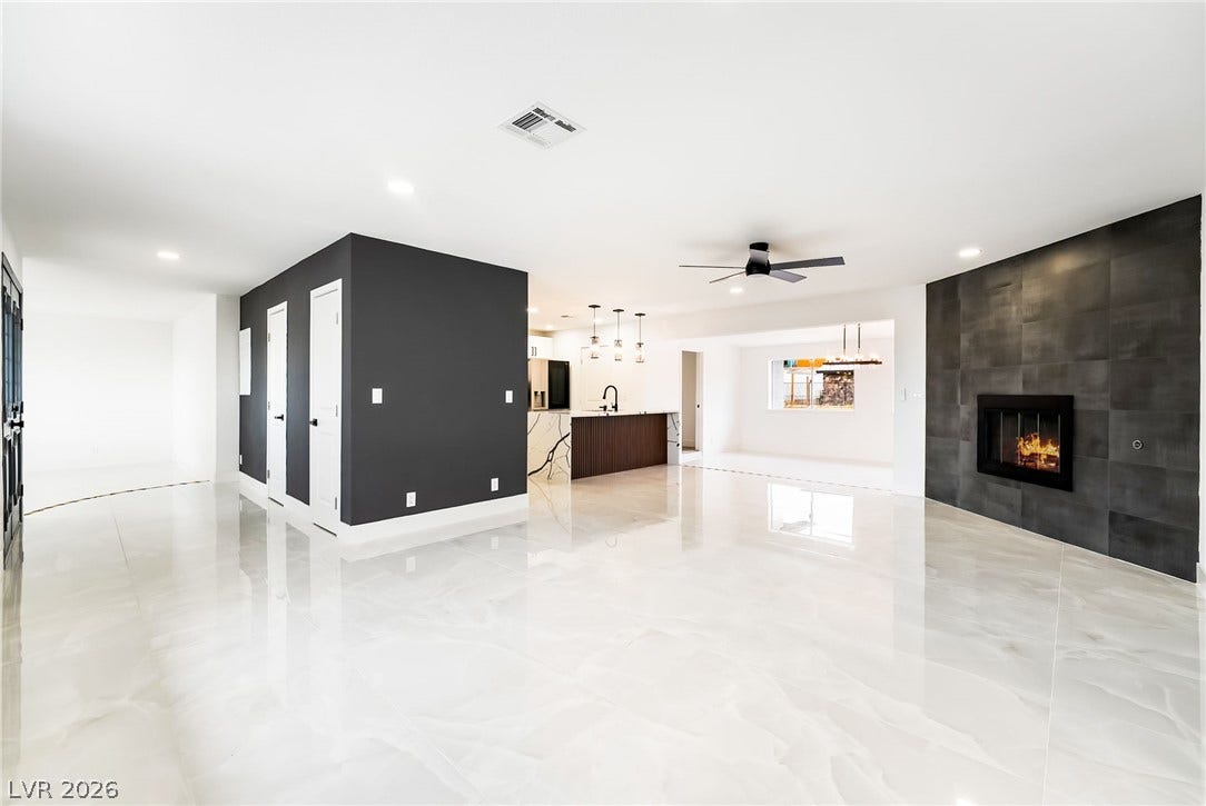 Polished tile flooring and a modern tile fireplace anchor this airy open living area.