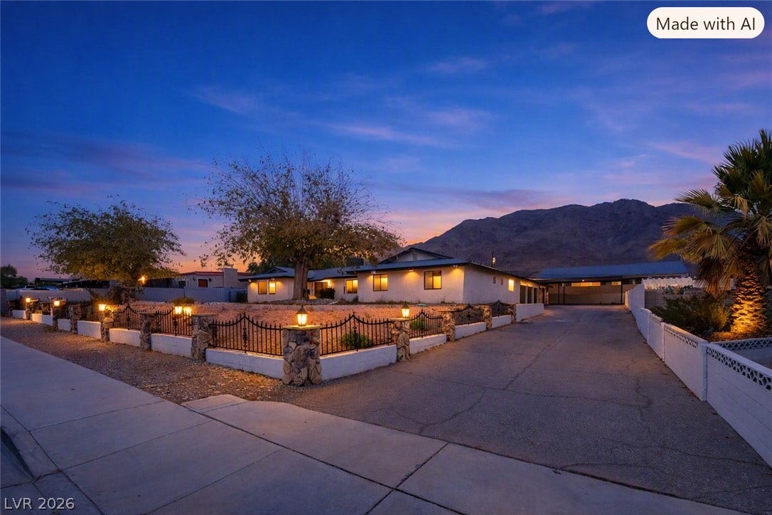 Dramatic mountain views provide a scenic backdrop for this single-level home with paved driveway.