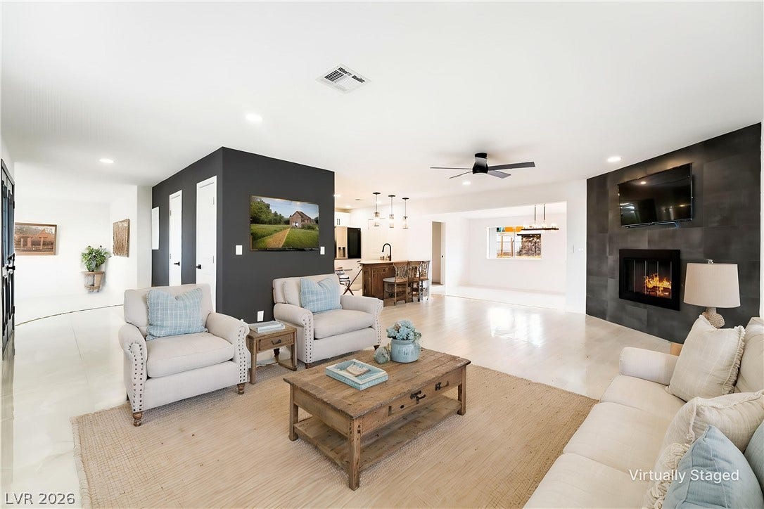 An open floorplan connects the inviting living room to the kitchen and dining areas.