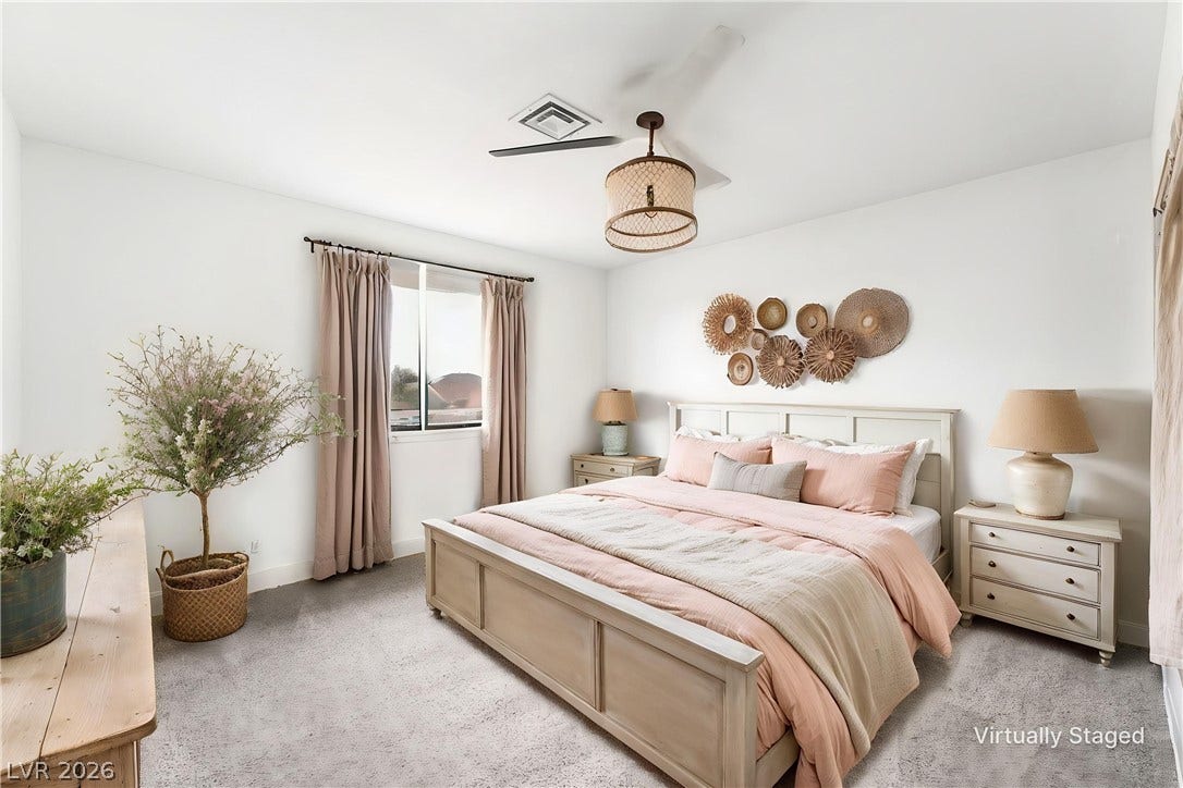 Soft carpet flooring and natural light from a wide window define this comfortable bedroom.