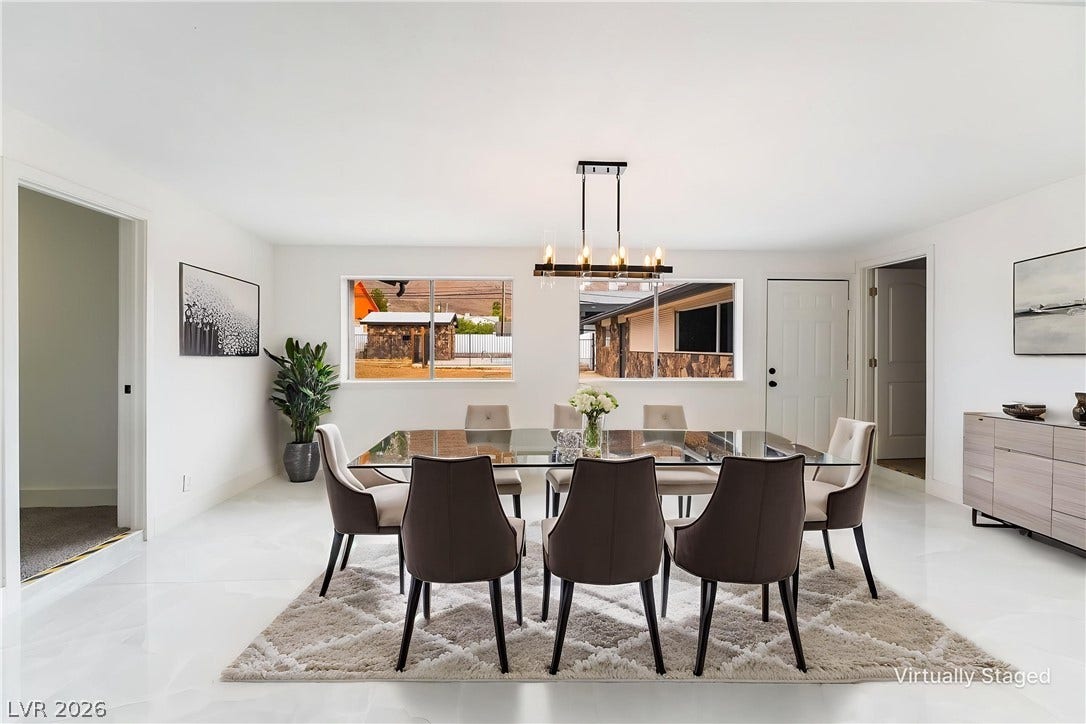 Polished tile flooring and dual wide windows define this airy dining space.