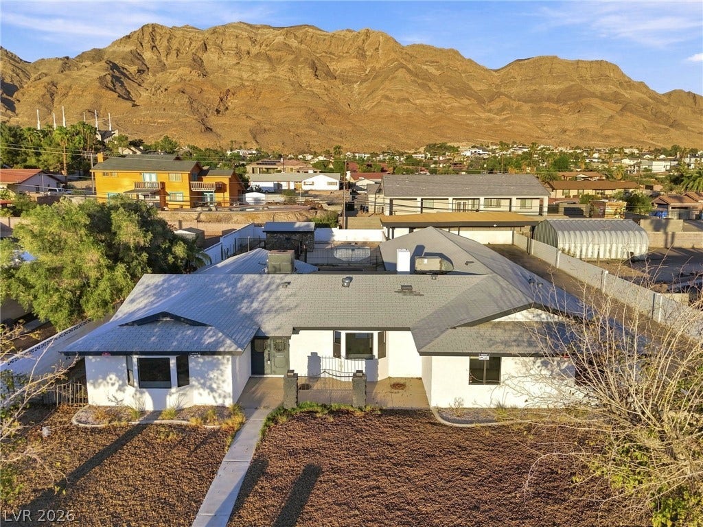 Dramatic mountain backdrops frame this single-story residence situated in a scenic neighborhood setting.
