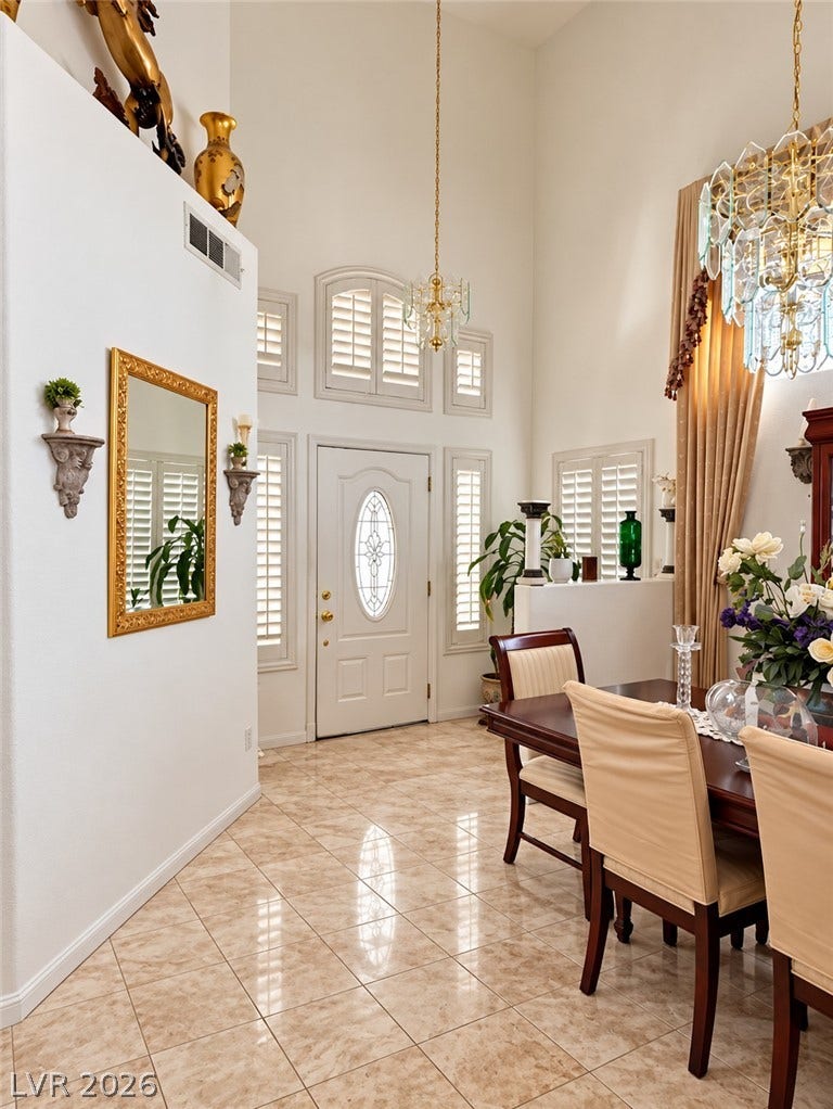 3925 Lilac Haze Street, Las Vegas, NV 89147 A soaring ceiling rises above polished tile flooring in this grand formal entry.