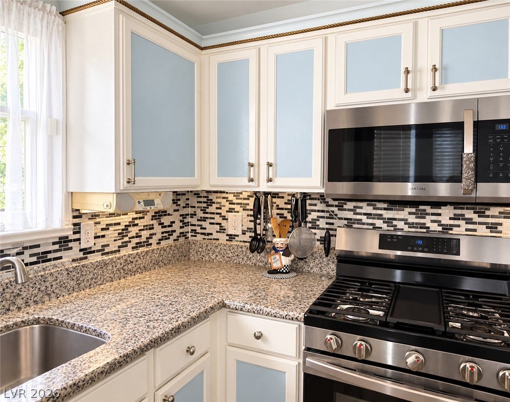3925 Lilac Haze Street, Las Vegas, NV 89147 Polished granite countertops pair elegantly with classic cabinetry and modern appliances.