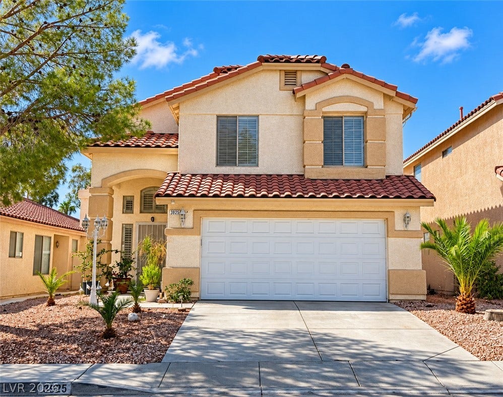 3925 Lilac Haze Street, Las Vegas, NV 89147 Spanish tile roofing and stucco exterior walls create classic curb appeal for this two-story home.