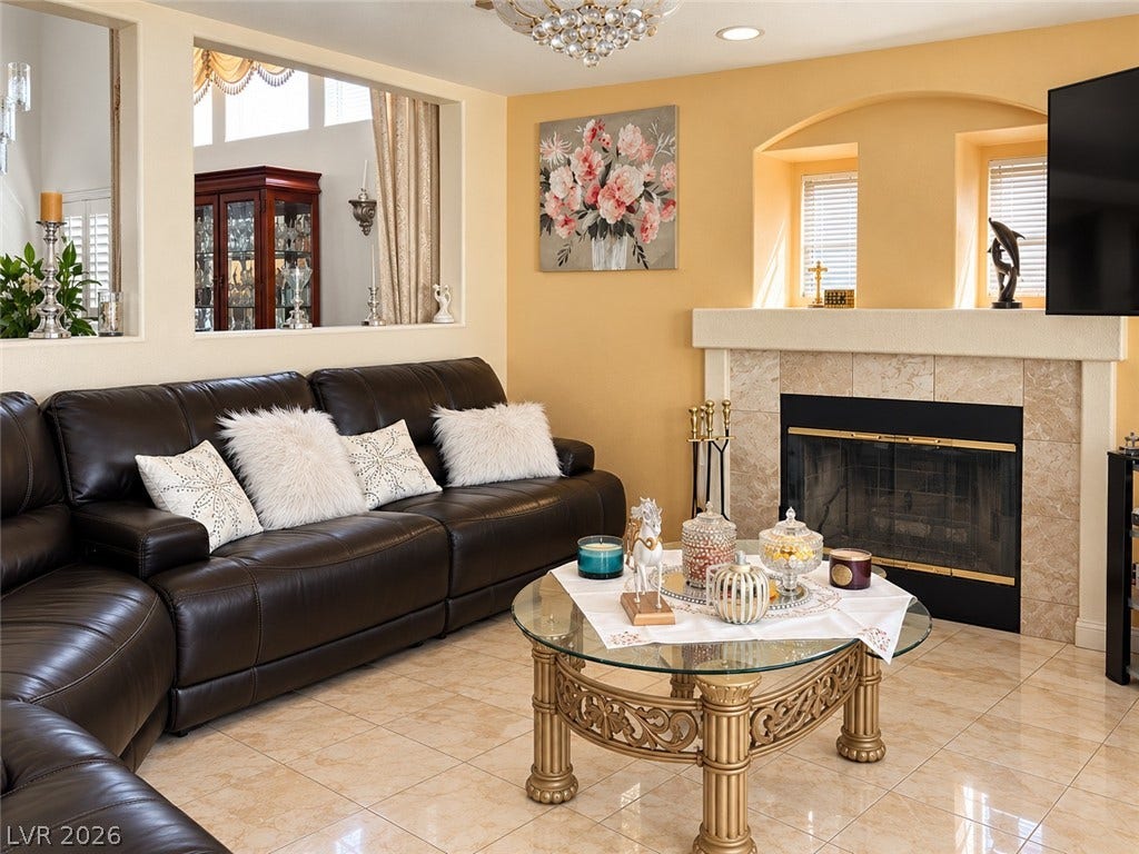 3925 Lilac Haze Street, Las Vegas, NV 89147 Polished tile flooring and an elegant fireplace create a warm, inviting living space.
