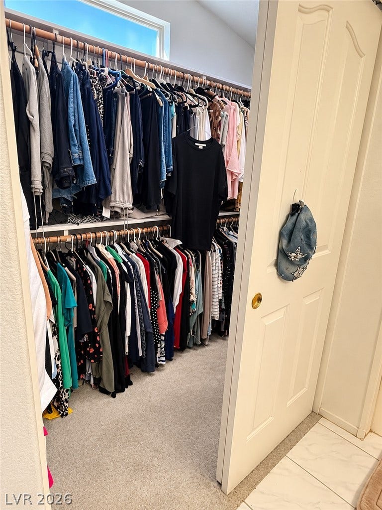 3925 Lilac Haze Street, Las Vegas, NV 89147 An abundance of hanging storage options defines this carpeted wardrobe space.