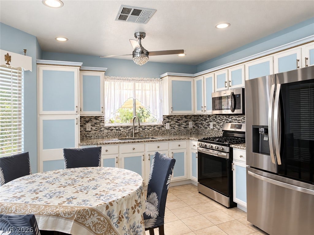 3925 Lilac Haze Street, Las Vegas, NV 89147 Ample cabinetry and stone countertops frame this functional workspace.