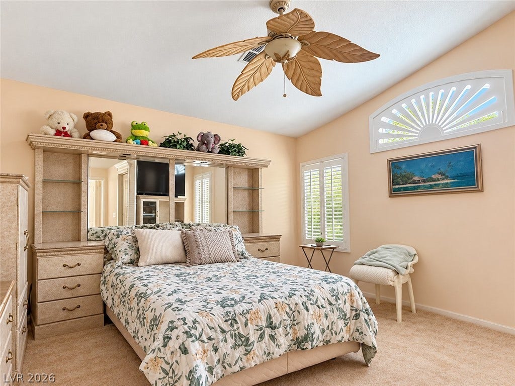 3925 Lilac Haze Street, Las Vegas, NV 89147 Vaulted ceilings and plantation shutters define this cozy bedroom space.
