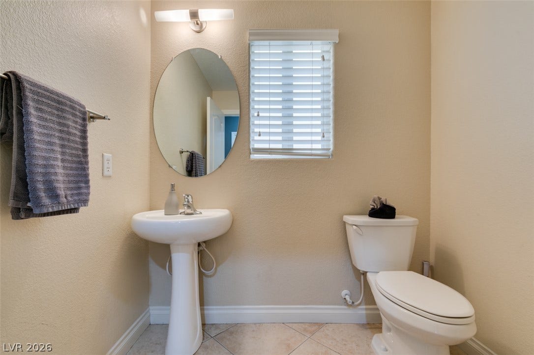 3166 E Eldorado Lane, Las Vegas, NV 89120 A classic pedestal sink pairs with diagonal tile flooring in this functional half bath.