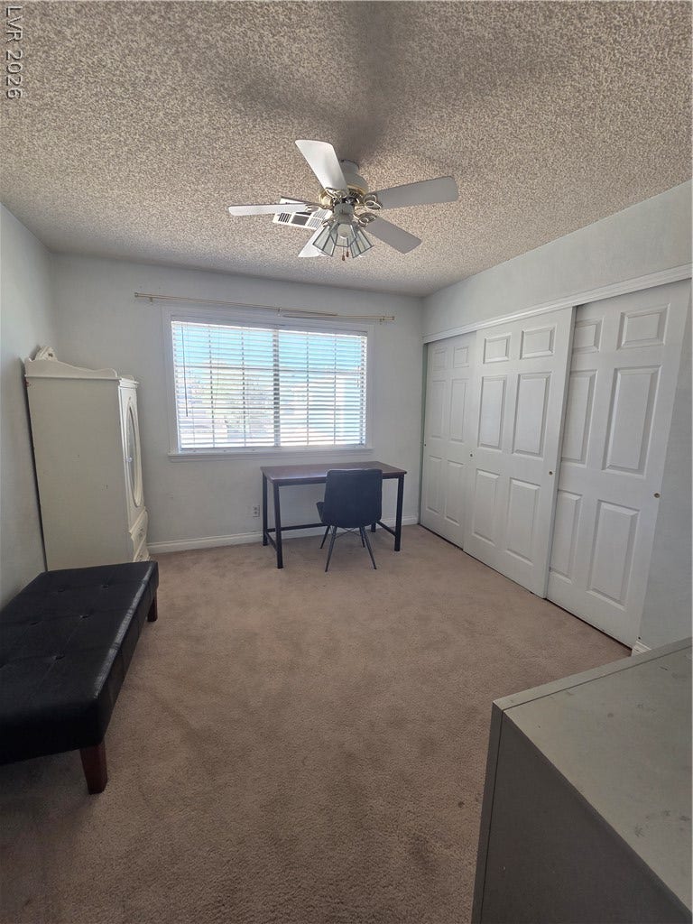 1429 Hawkwood Road, Henderson, NV 89014 A quiet bedroom features wall-to-wall carpeting and a wide closet with sliding doors.