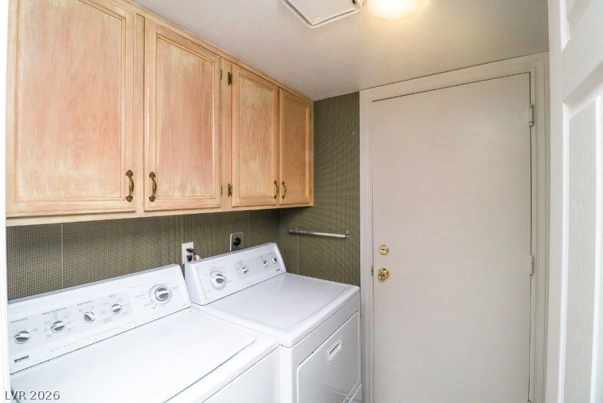 1429 Hawkwood Road, Henderson, NV 89014 Functional workspace features built-in upper cabinetry and dedicated washer and dryer installations.
