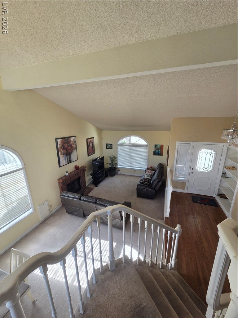 1429 Hawkwood Road, Henderson, NV 89014 An inviting entryway leads down to a sunken living room with fireplace and vaulted ceilings.