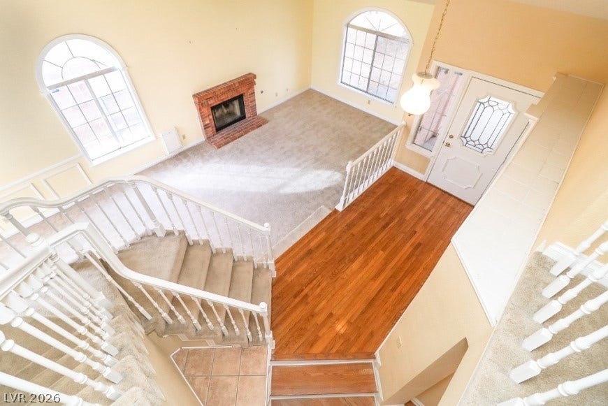 1429 Hawkwood Road, Henderson, NV 89014 High ceilings and arched windows illuminate this versatile multi-level living space with a classic fireplace.
