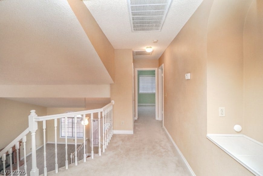 1429 Hawkwood Road, Henderson, NV 89014 An upper hallway overlooks the lower-level living space via a classic banister.