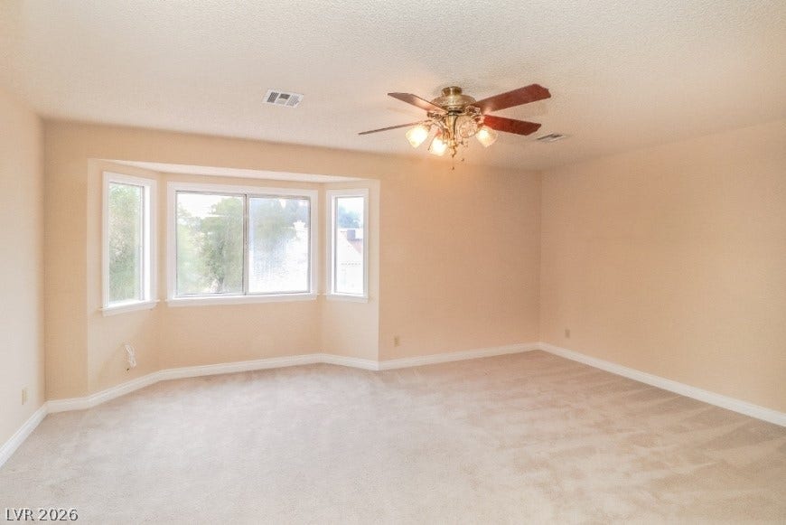 1429 Hawkwood Road, Henderson, NV 89014 Plentiful natural light streams through a classic bay window into this comfortable, carpeted space.