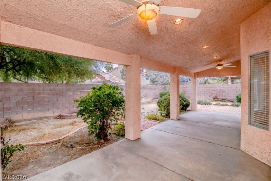 1429 Hawkwood Road, Henderson, NV 89014 A deep covered patio overlooks the walled backyard with mature desert landscaping.