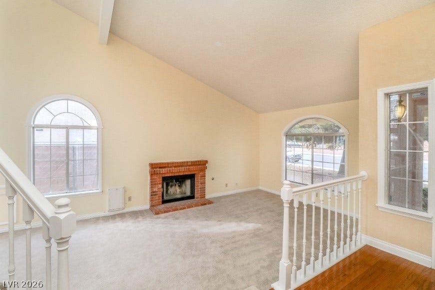 1429 Hawkwood Road, Henderson, NV 89014 A classic brick fireplace anchors the living space under vaulted ceilings and arched windows.